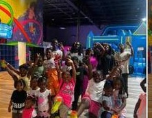 Kids with hands raised at field trip